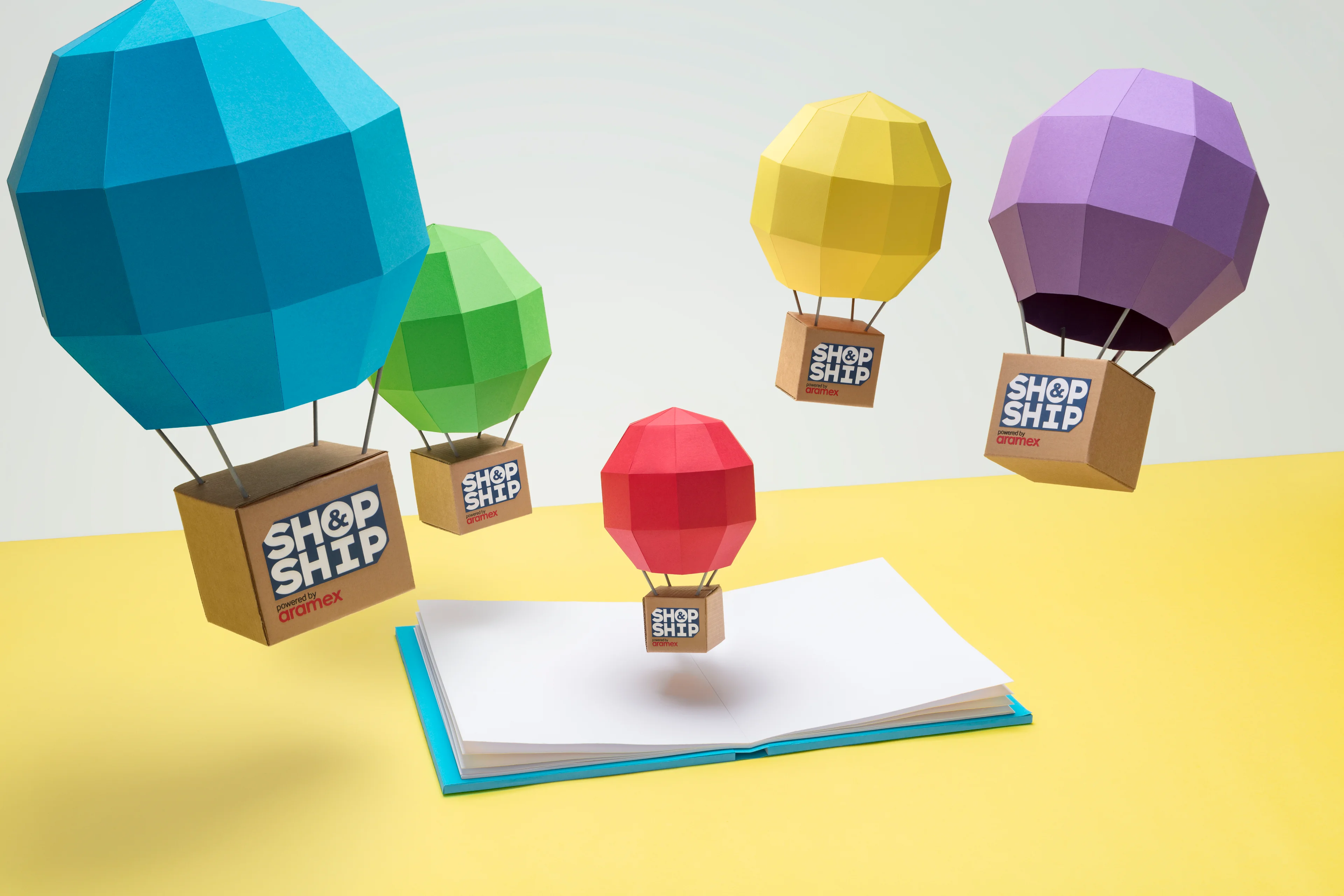 Shop & Ship paper-craft hot-air balloon packages representing global delivery