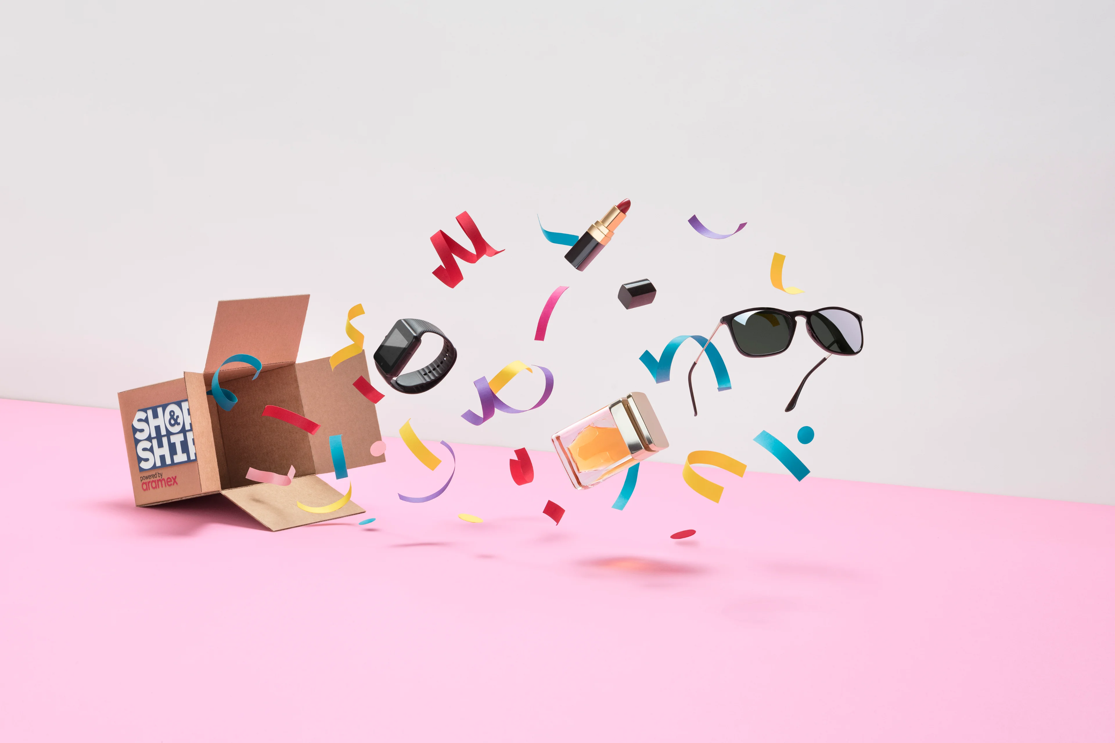 Shop & Ship paper-craft open package with fashion, beauty and lifestyle products.