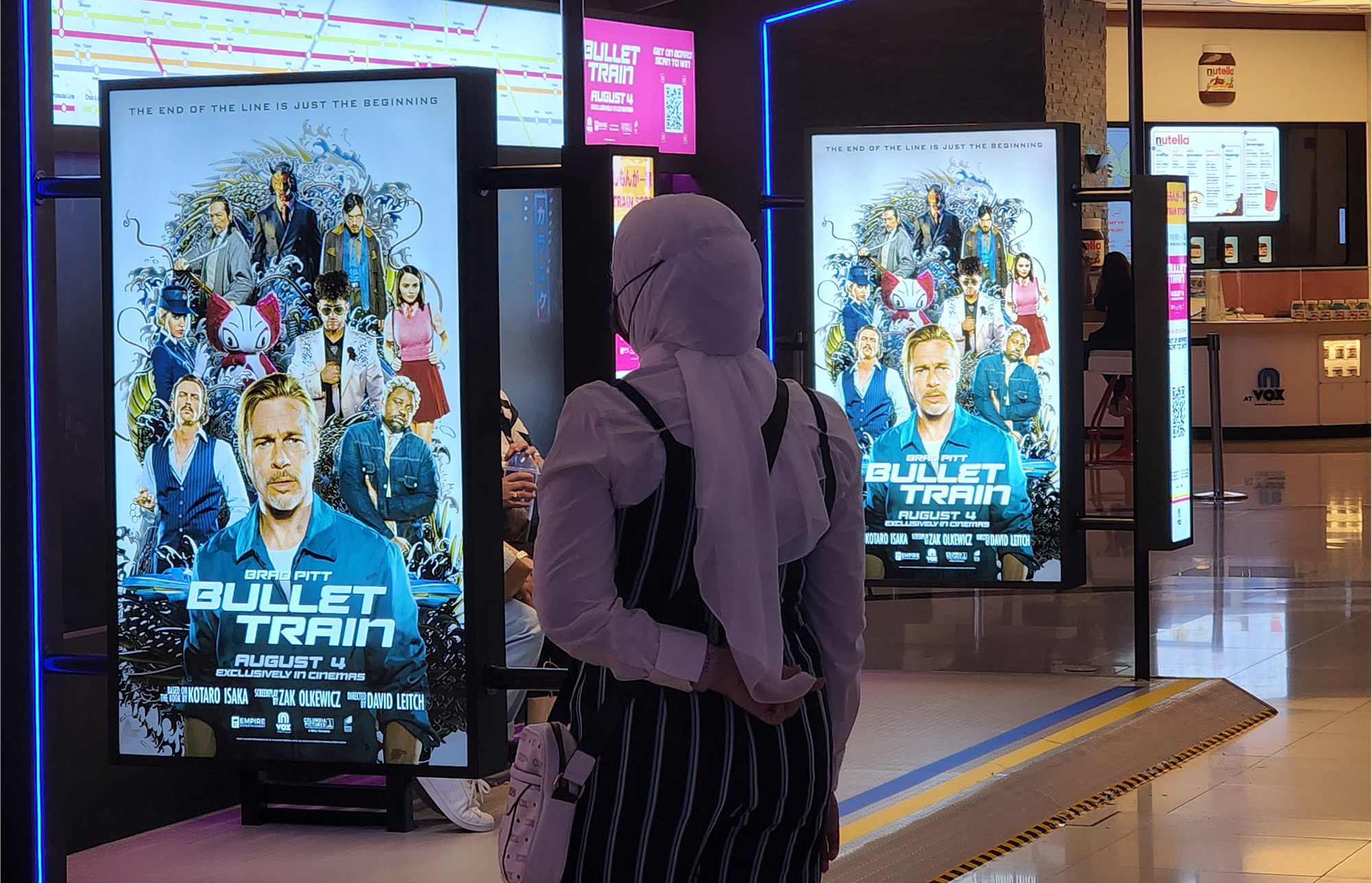 Moviegoer standing in front of the Bullet Train Station. Moviegoer standing in front of the Bullet Train Station.